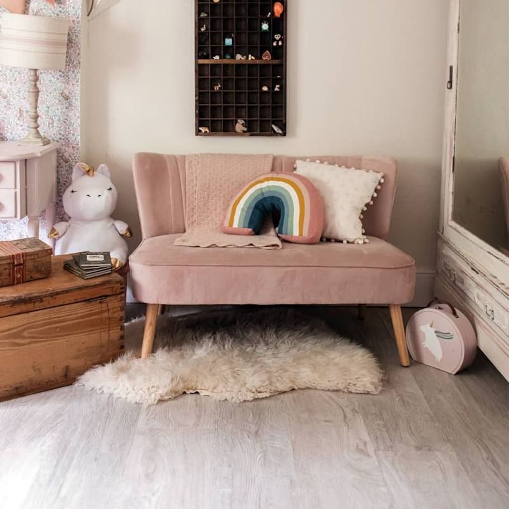 White Oak wood effect flooring in a children's bedroom with pink furniture and rainbow cushion